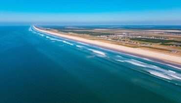 Aerial view of the Outer Banks coastline with beach houses and the Atlantic Ocean